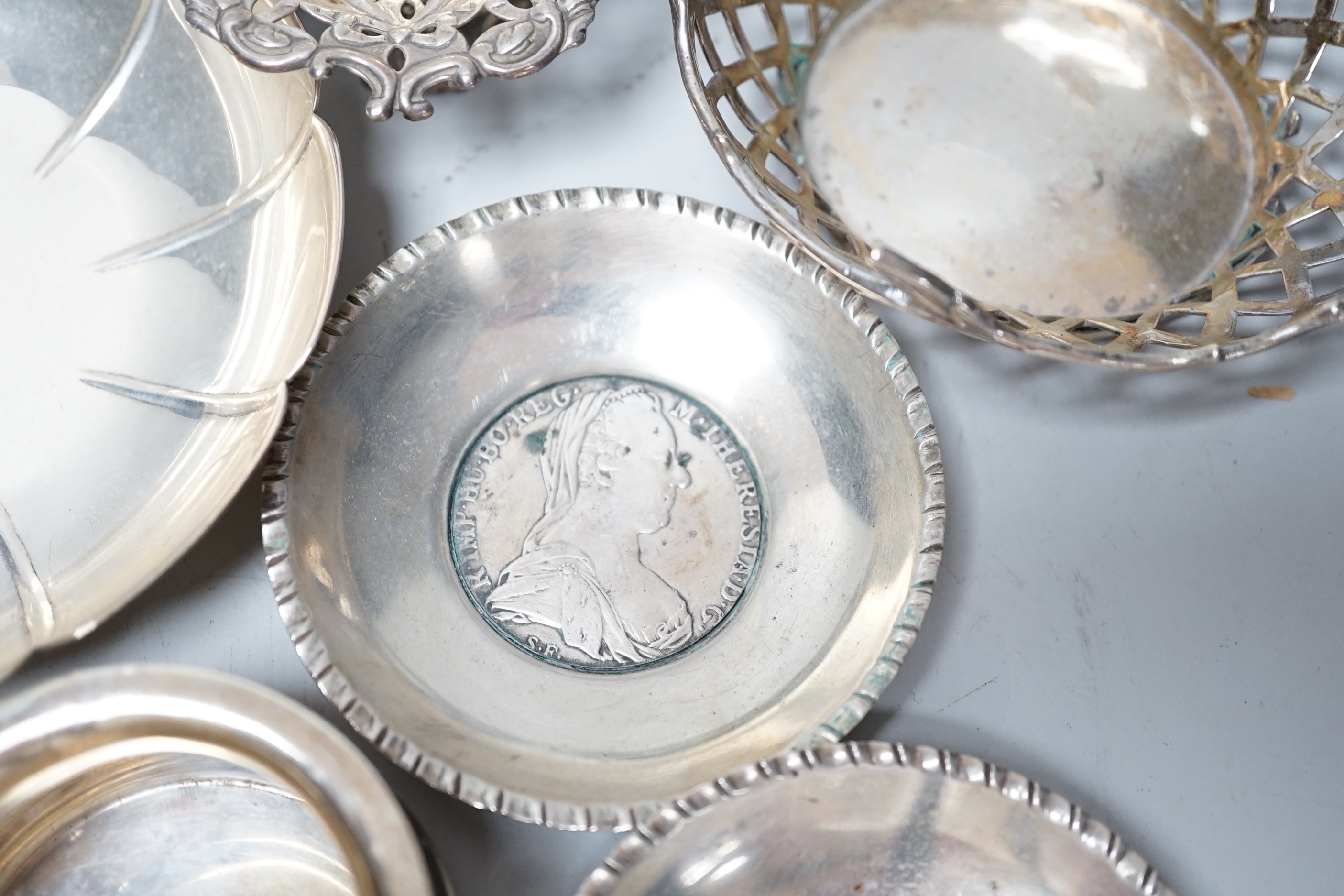 A modern pair of small silver mounted coasters, diameter 79mm, seven other silver or white metal dishes including Dutch and a small silver cream jug.